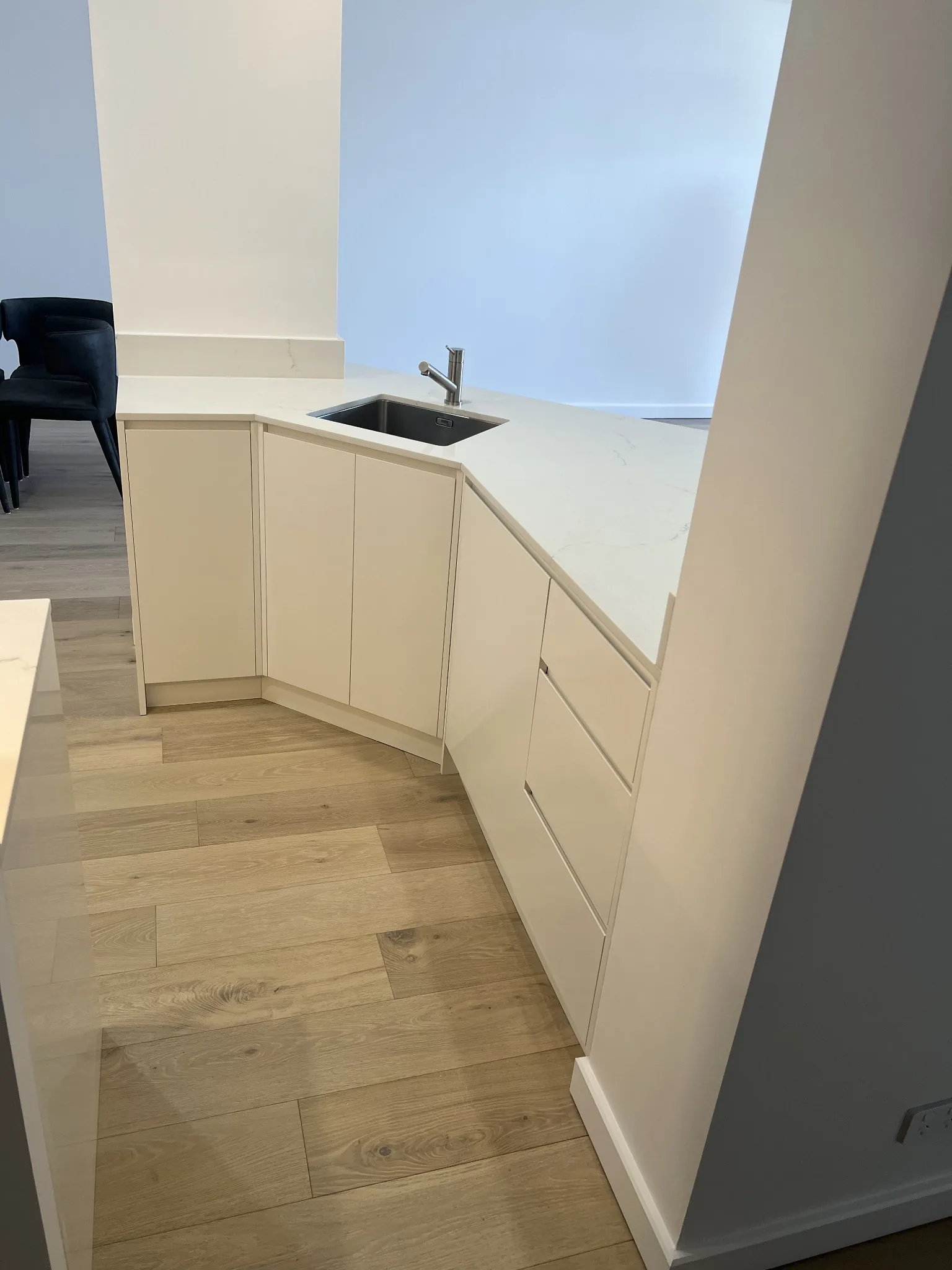 Compact white corner kitchen joinery